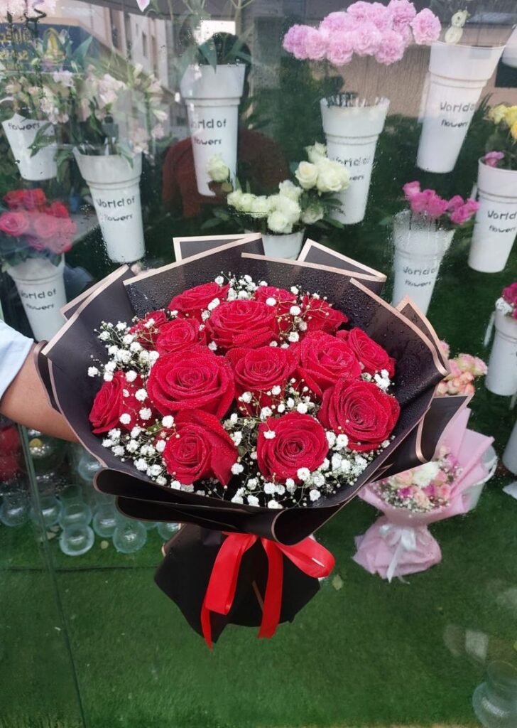 Graduation flower bouquet with roses and baby’s breath, delivered to University City Hall Sharjah for AUS and Sharjah University students.