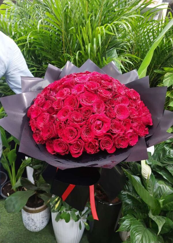 Elegant 100 red roses bouquet beautifully arranged for romantic occasions and special celebrations.