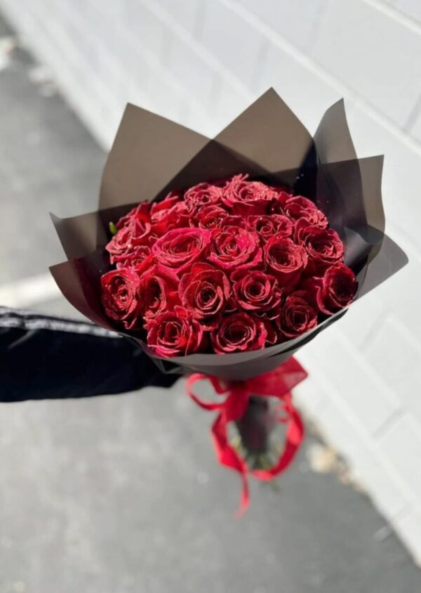 Luxurious bouquet of 25 fresh red roses wrapped in elegant packaging, perfect for romantic occasions.