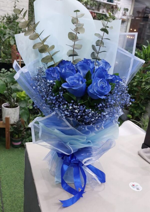 10pcs blue roses bouquet with baby's breath and eucalyptus leaves elegantly wrapped for special occasions in Dubai.