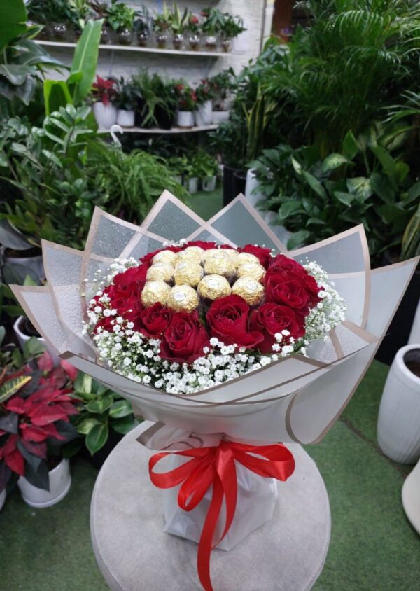 Luxurious Red Roses and Ferrero Rocher Bouquet with baby's breath, wrapped in premium floral paper and tied with a red ribbon.