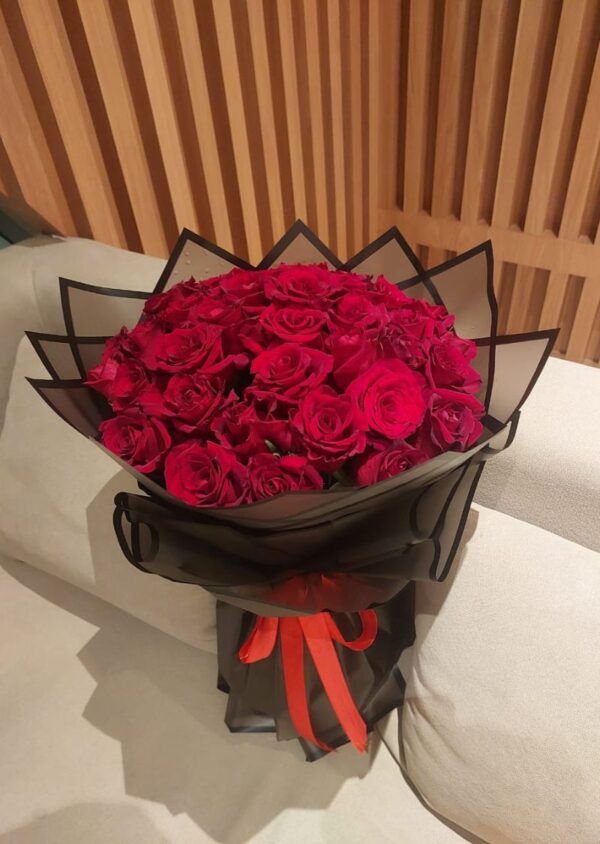 51 red roses bouquet in black wrapping with red ribbon, perfect for romantic gifts and flower delivery in UAE.