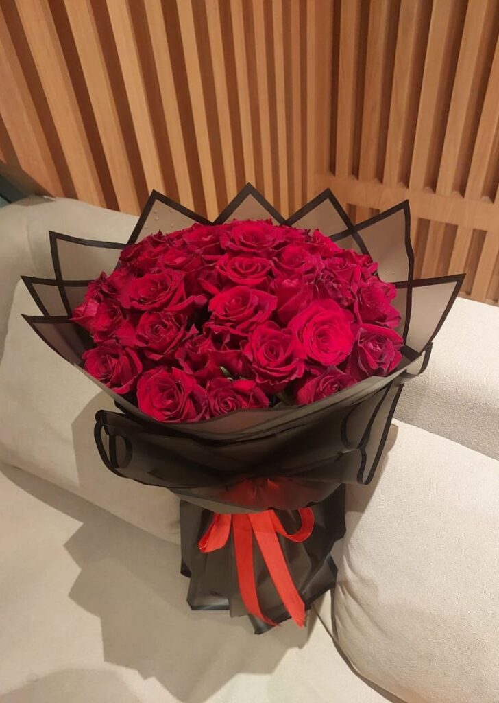 51 red roses bouquet in black wrapping with red ribbon, perfect for romantic gifts and flower delivery in UAE.