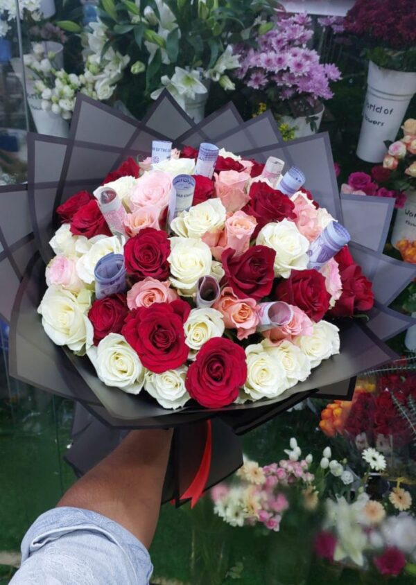 Luxury bouquet of red, white, pink, and peach roses with rolled currency notes arranged as a premium gift in UAE.