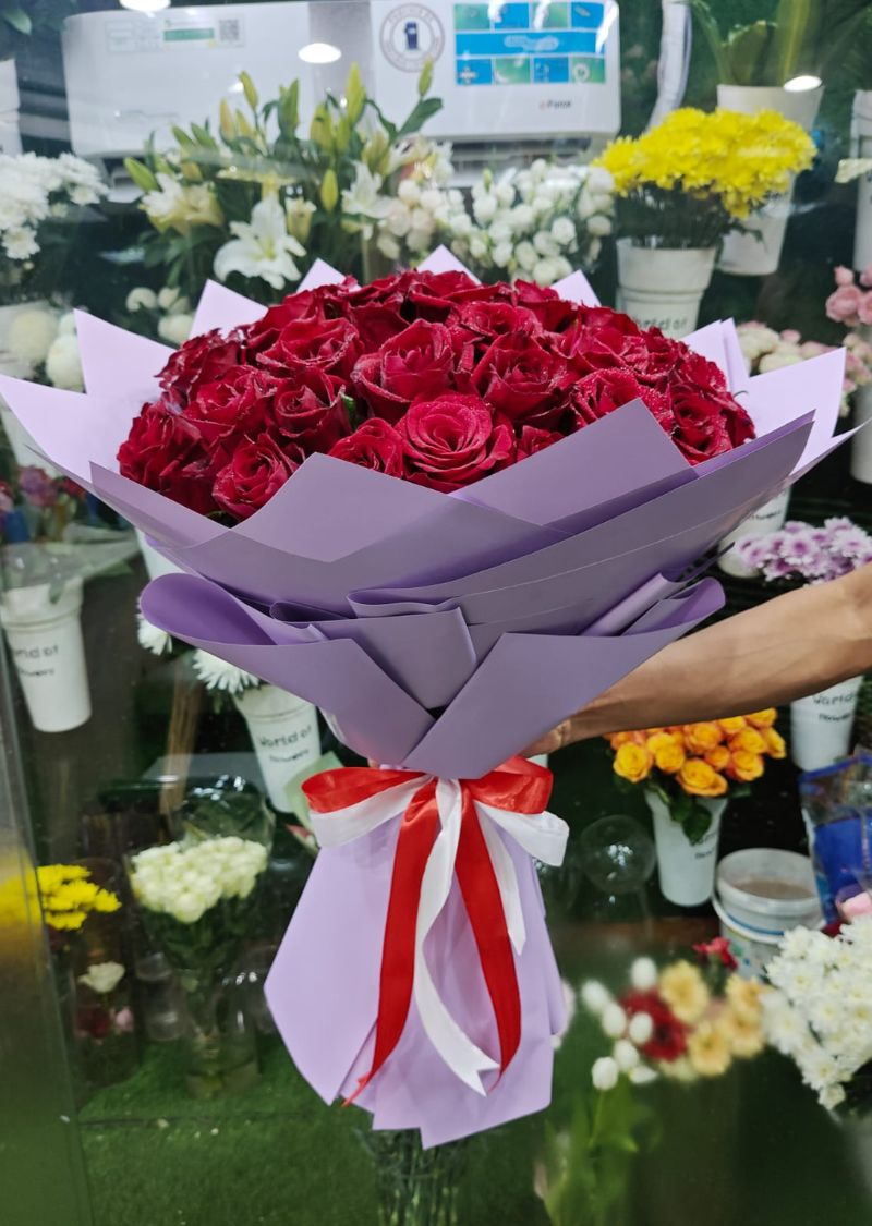Red Rose Bouquet in Purple Wrap – Same Day Flower Delivery Across UAE
