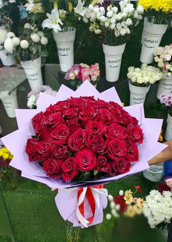 Red rose bouquet with purple wrap and ribbon for delivery in Sharjah UAE
