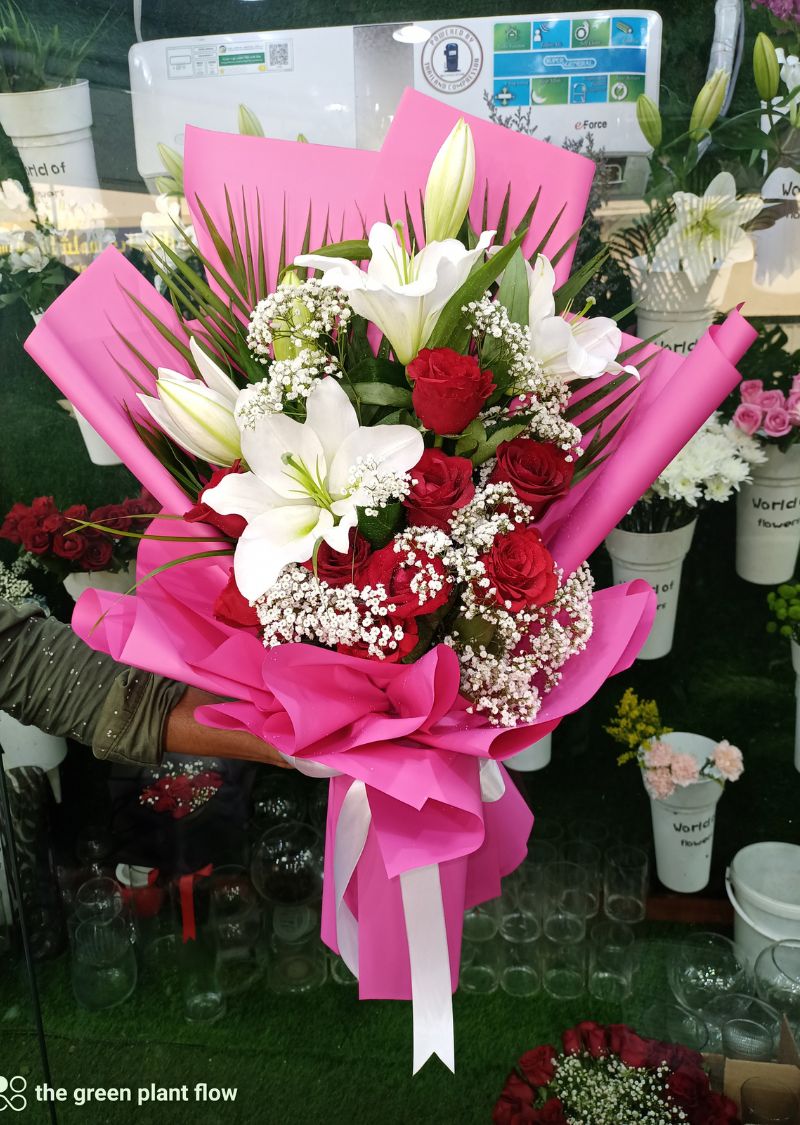 Elegant red roses and white lily bouquet with premium pink wrapping in Dubai