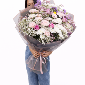 Luxury pastel flower bouquet handcrafted by professional florist with fresh roses and carnations