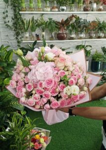 Luxury pink rose and hydrangea bouquet with elegant pastel wrapping