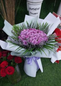 purple roses bouquet with luxury white wrapping and lavender ribbon