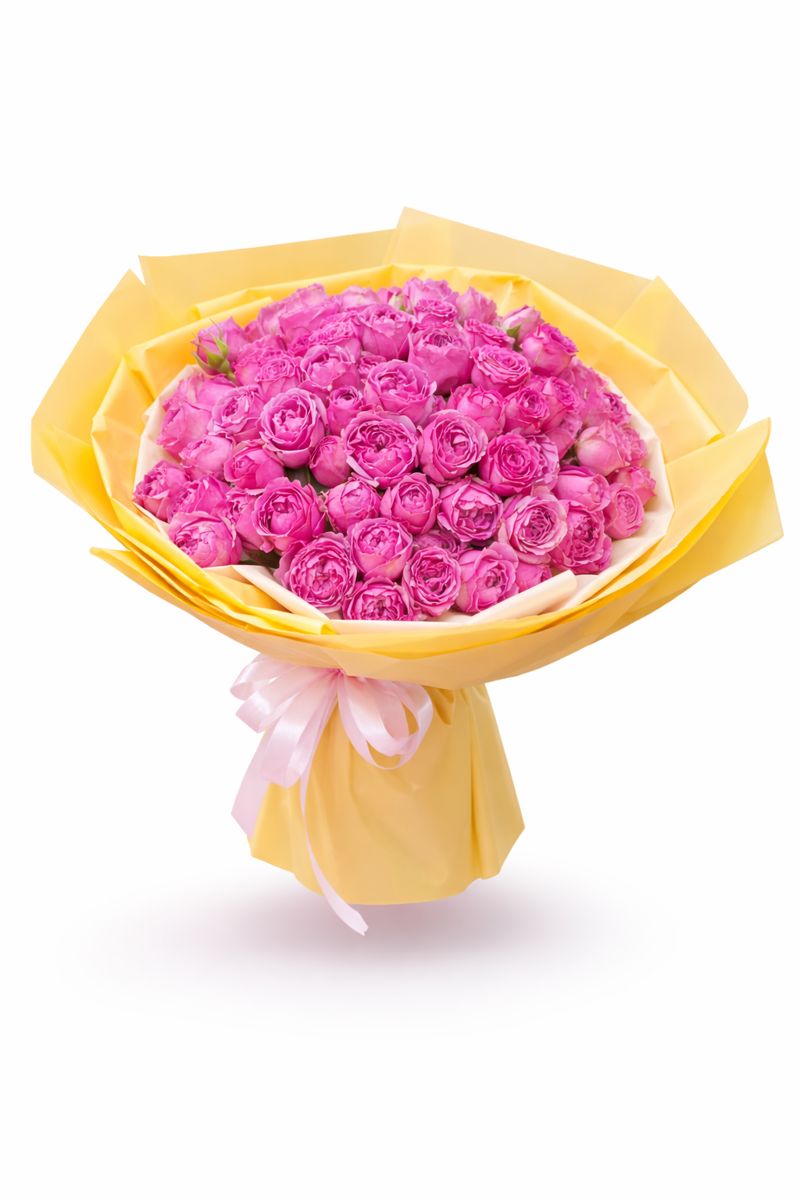 Vibrant mixed floral bouquet with premium pink roses wrapped in elegant yellow paper