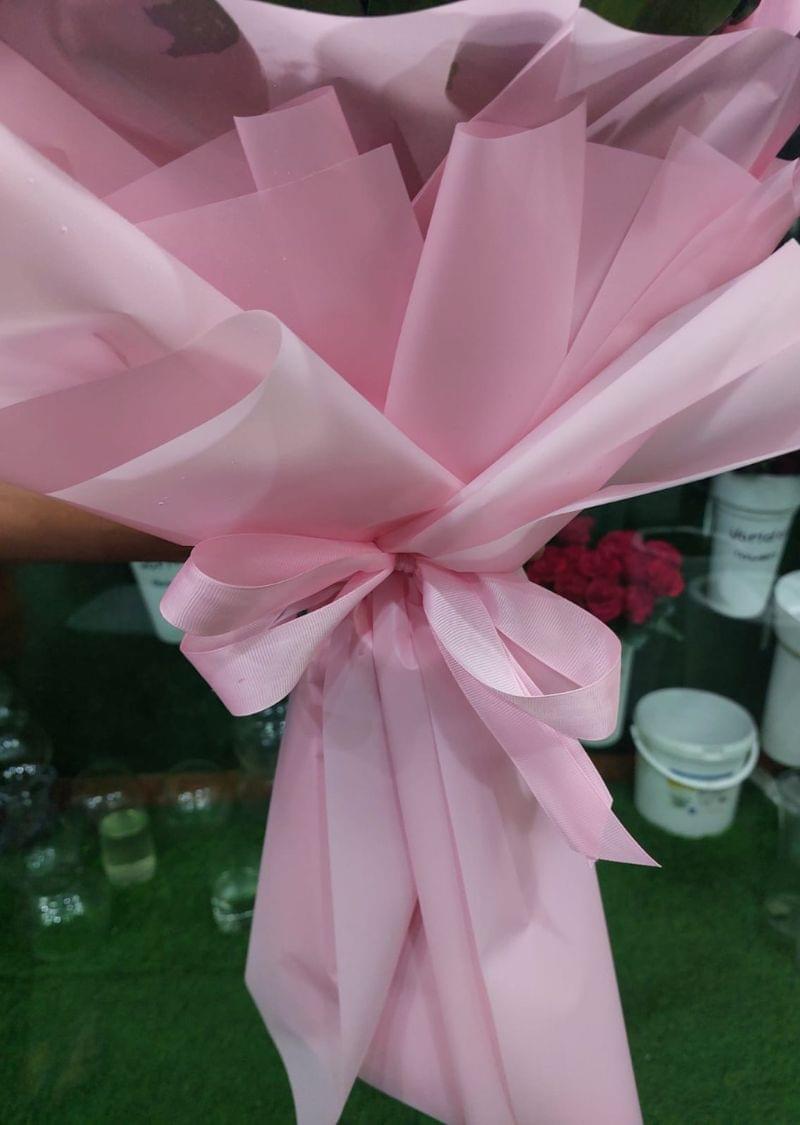 Premium pink rose bouquet wrapped in pink paper with greenery, perfect for special occasions and delivery in Dubai.