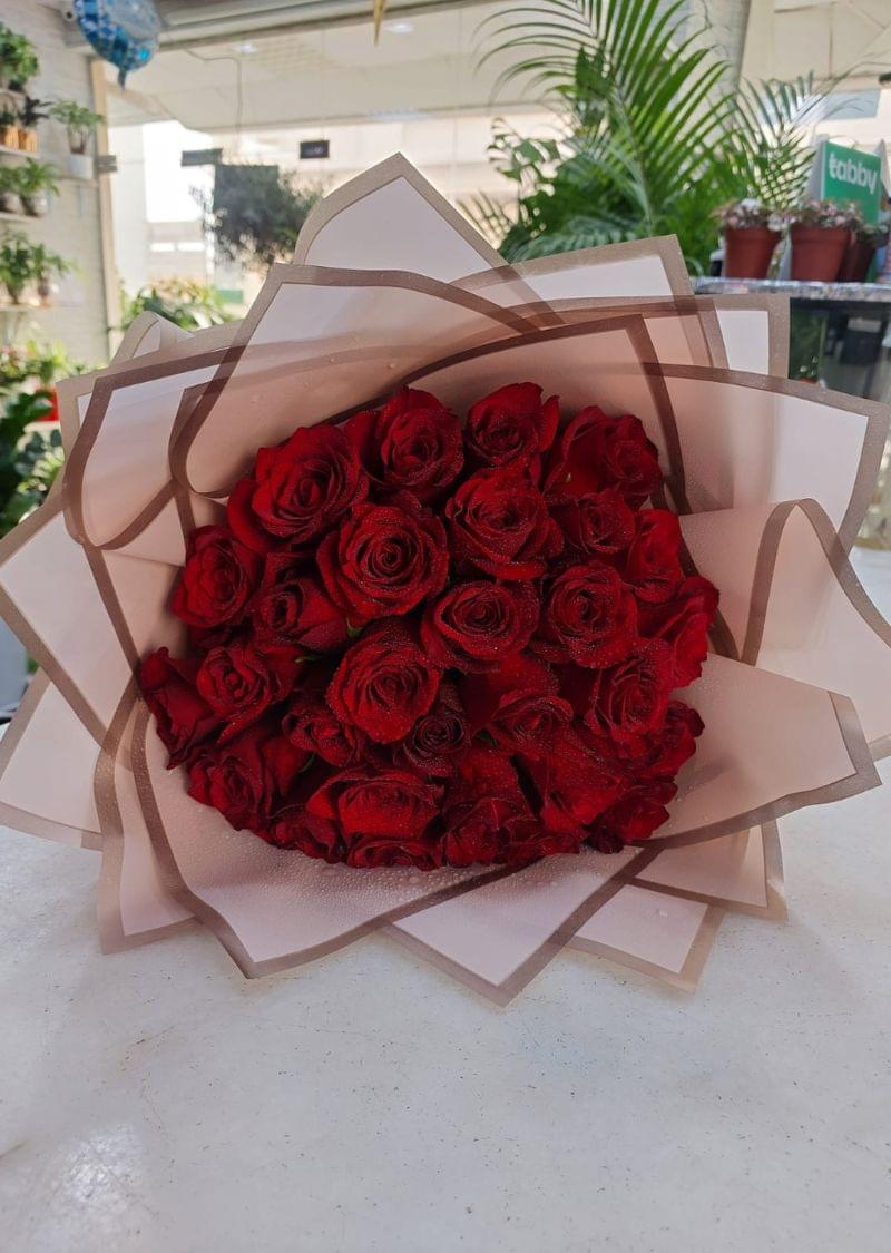 30 red roses bouquet elegantly wrapped with a red ribbon, perfect for romantic occasions and gift delivery in Dubai.