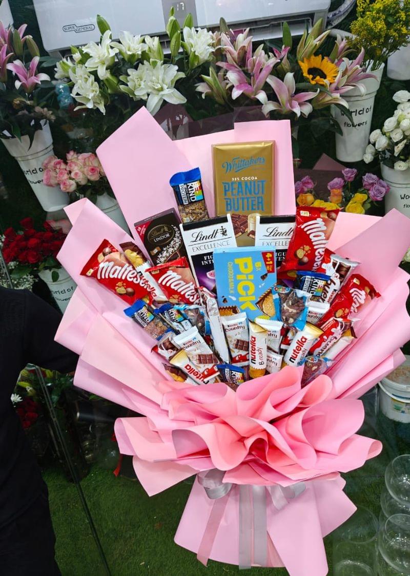 Customize chocolate bouquet with assorted chocolates wrapped in pink paper, available in Sharjah