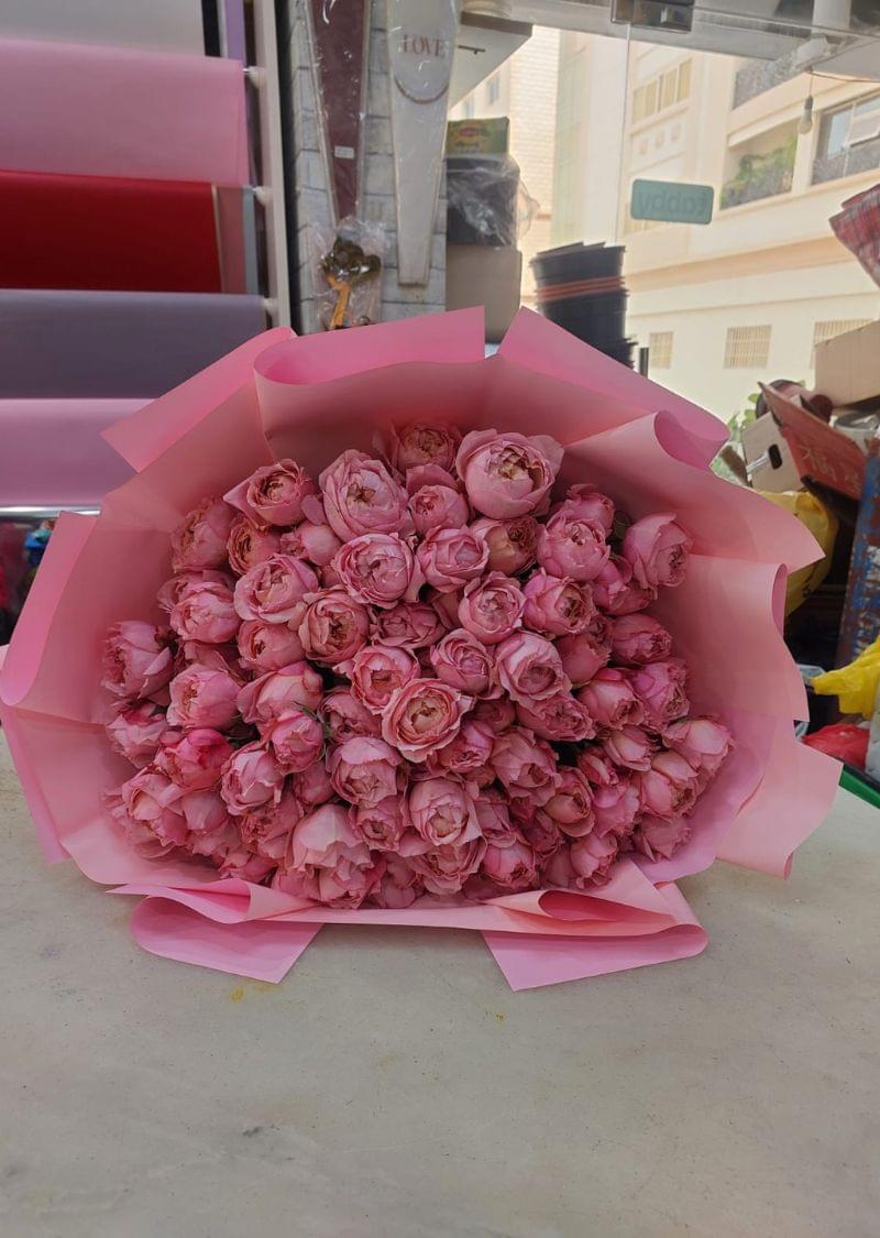 Hand-tied pink roses bouquet available for flower delivery in Sharjah