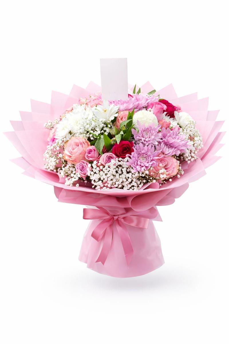 Luxury mixed flower bouquet with pink roses, chrysanthemums, and baby’s breath wrapped in elegant pink paper